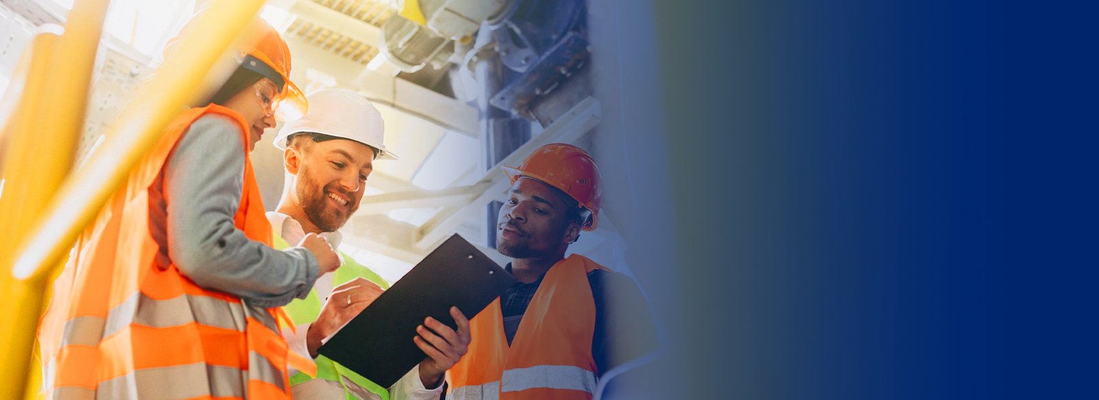 Construction workers reviewing a clipboard together on site