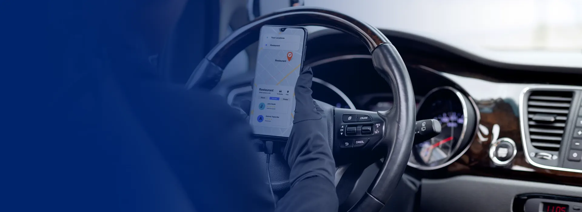 Driver using a route-planning app on a mobile phone while behind the wheel